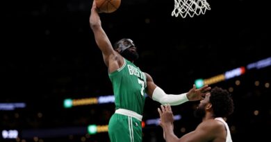 NBA: Jaylen Brown #7 of the Boston Celtics dunks the ball over Joel Embiid #21 of the Philadelphia 76ers during the second half of game two of the Eastern Conference Second Round Playoffs at TD Garden on May 03, 2023 in Boston, Massachusetts. The