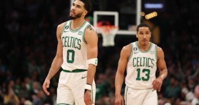 Jayson Tatum #0 and Malcolm Brogdon #13 of the Boston Celtics walk backcourt during the fourth quarter of game one of the Eastern Conference Finals against the Miami Heat at TD Garden on May 17, 2023 in Boston, Massachusetts.