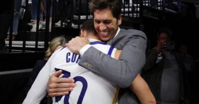 (FILES) Stephen Curry of the Golden State Warriors hugs general manager Bob Myers after the Warriors defeated the Kings 120-100 in game seven of the Western Conference First Round Playoffs at Golden 1 Center on April 30, 2023