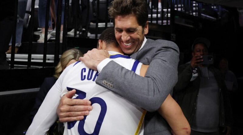 (FILES) Stephen Curry of the Golden State Warriors hugs general manager Bob Myers after the Warriors defeated the Kings 120-100 in game seven of the Western Conference First Round Playoffs at Golden 1 Center on April 30, 2023