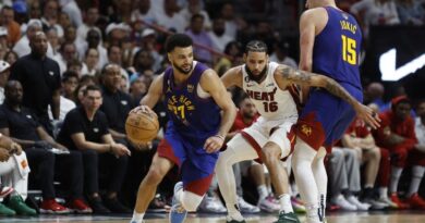 Jamal Murray #27 of the Denver Nuggets dribbles past a screen set by Nikola Jokic #15 against Caleb Martin #16 of the Miami Heat during the fourth quarter in Game Three of the 2023 NBA Finals at Kaseya Center on June 07, 2023 in Miami, Florida