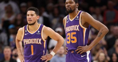 Devin Booker #1 and Kevin Durant #35 of the Phoenix Suns stand on the court during a timeout form the second half of the NBA game against the Minnesota Timberwolves at Footprint Center on March 29, 2023 in Phoenix, Arizona.