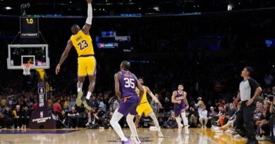 Los Angeles Lakers forward LeBron James (23) reaches for a inbound pass intended for Phoenix Suns forward Kevin Durant (35) during the second half of an NBA basketball game Thursday, Oct. 26, 2023, in Los Angeles.